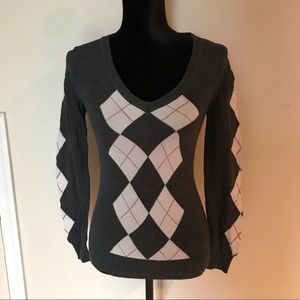 Gray argyle sweater with red and white accents